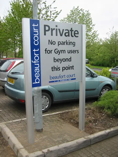 Large parking information sign featuring company name