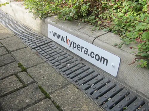 Company name parking sign attached to kurb