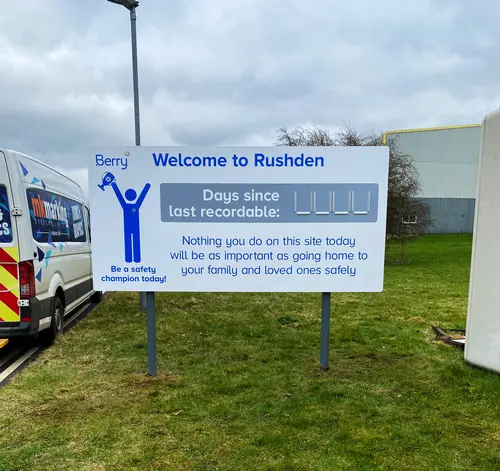 Large parking information sign featuring company name