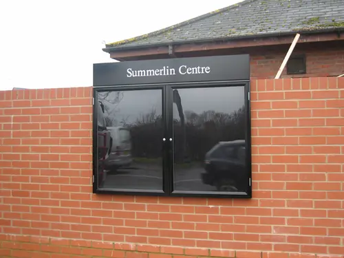 Exterior wall mounted notice board with doors