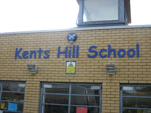 School raised letter on brick