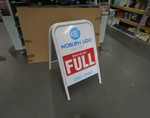 A now open A board for a local Indian Restaurant showing pricing information