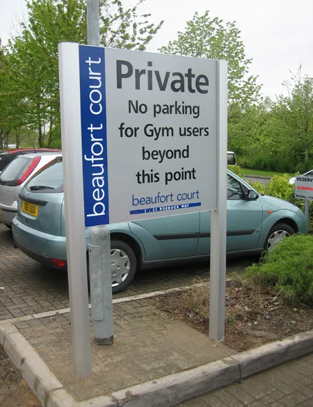 Large parking information sign featuring company name
