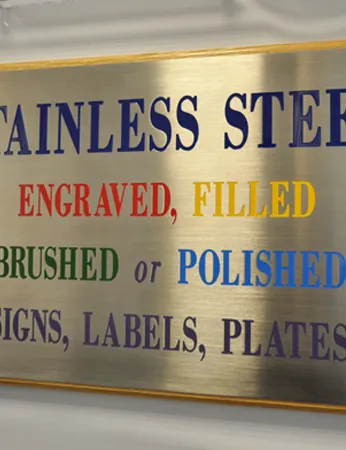 A Metal Plaque mounted on wooden display various styles of text