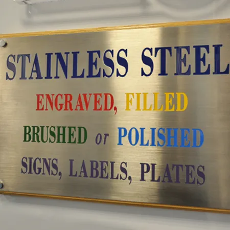 A Metal Plaque mounted on wooden display various styles of text