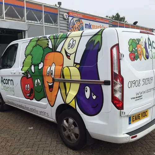 Van with sticker showing cartoon vegetables